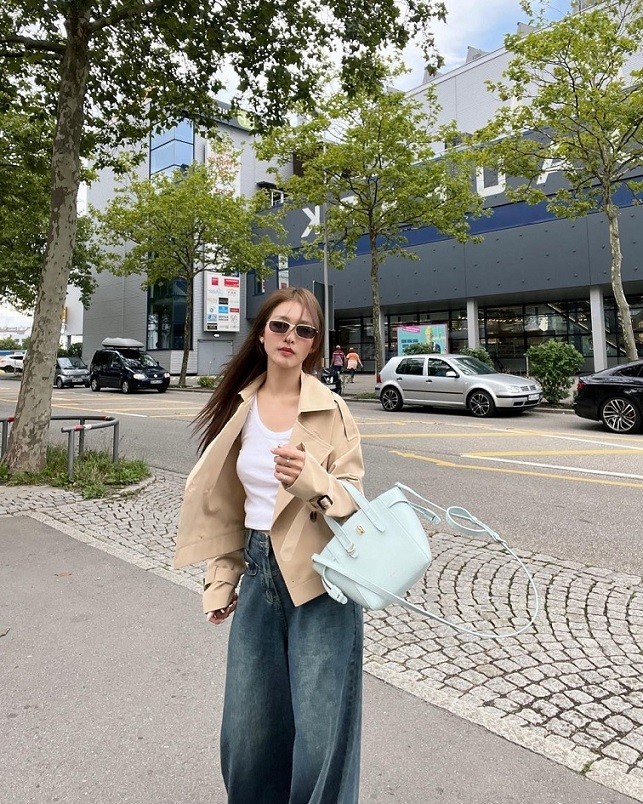 Với mẫu trench coat dáng ngắn, nữ diễn viên tạo vẻ sang chảnh khi phối quần jeans ống suông rộng. 