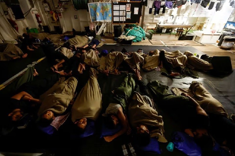 Những người di cư ngủ trên một boong tàu cứu hộ do tổ chức Bác sĩ không biên giới điều hành, trên đường đến Ý sau khi được giải cứu ở vùng biển quốc tế ngoài khơi Libya ngày 29/9/2023