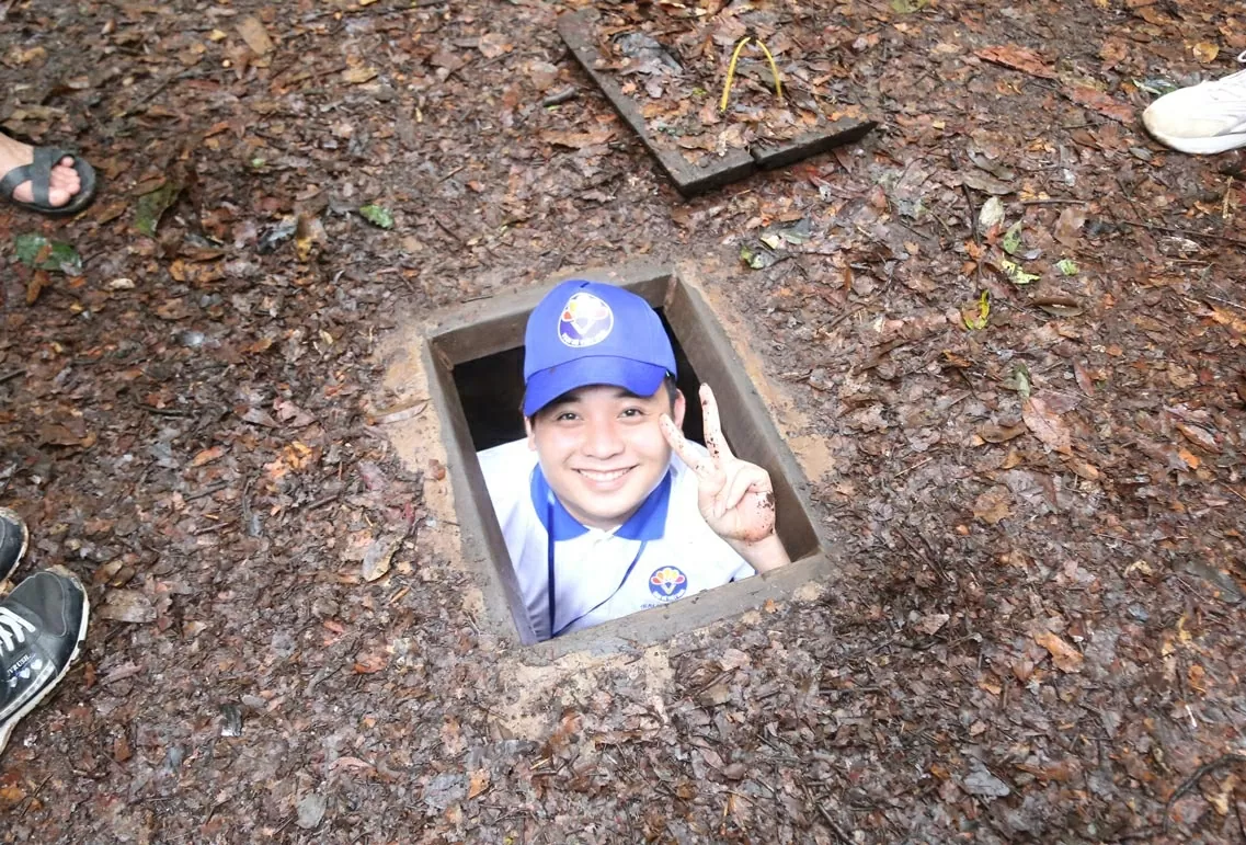 Kiều bào trẻ thích thú lần đầu tiên trải nghiệm chui địa đạo. (Ảnh: Thành Long)