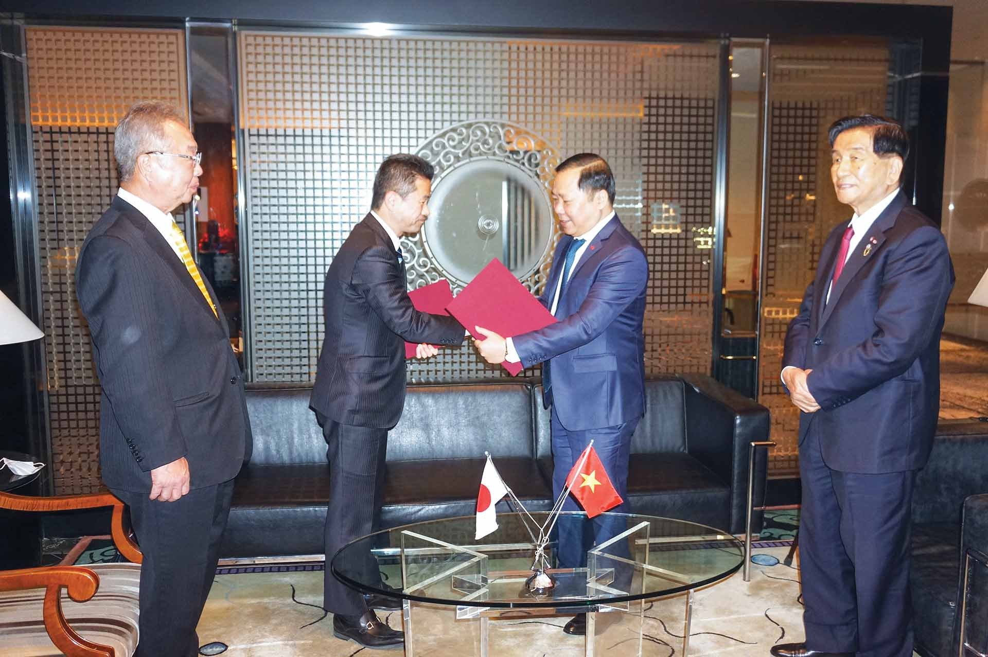 Ông Nguyễn Phi Long, Chủ tịch UBND tỉnh Bình Định (thứ hai từ phải) và ông Nakai Akimoto, Trưởng thị trấn Yoshino, tỉnh Nara, Nhật Bản trao Bản ghi nhớ về định hướng hợp tác. (Ảnh: H.L)