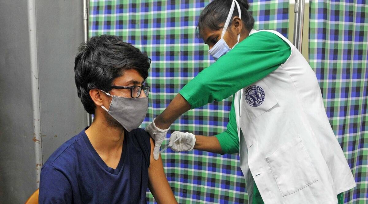 A young beneficiary gets Covid-19 vaccine at a vaccination centre in Sector 45 of Chandigarh. (Express Photo by Kamleshwar Singh) A young beneficiary gets Covid-19 vaccine at a vaccination centre in Sector 45 of Chandigarh. (Express Photo by Kamleshwar Singh)