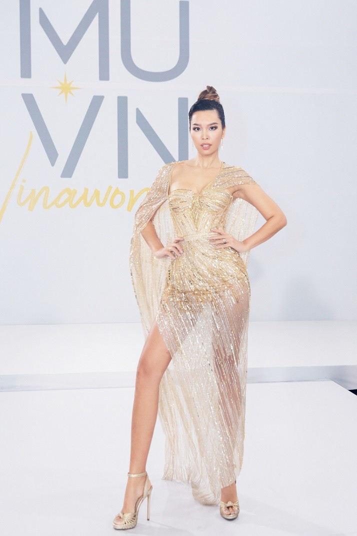 Hà Anh chọn thiết kế của Lê Thanh Hòa. Váy có đường xe cao, kết hợp áo choàng đính kết.