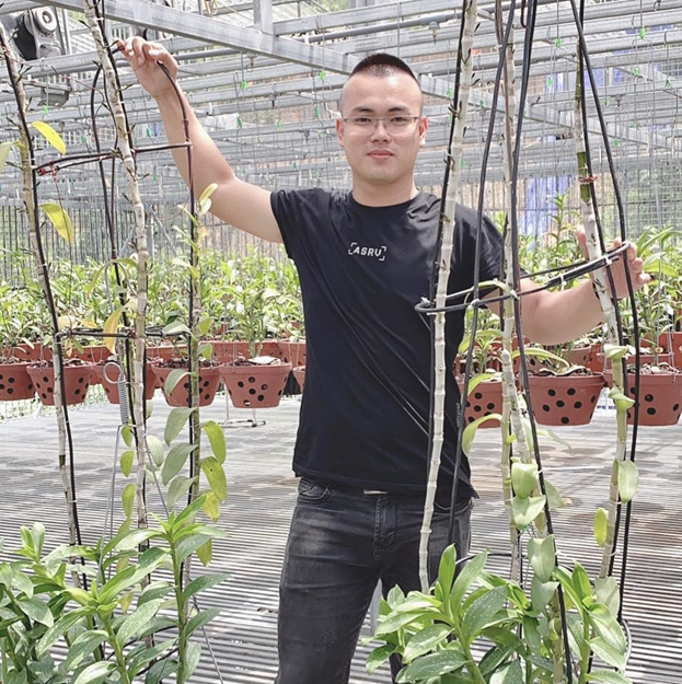 Anh Hoàng Hữu Trung bên vườn lan của mình.